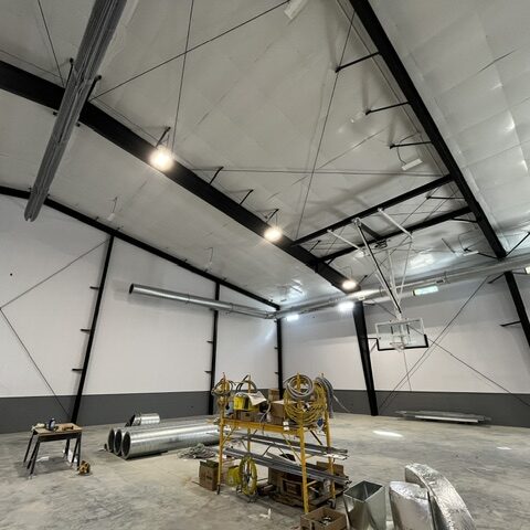 Commercial spiral ductwork and HVAC materials during installation in an athletic facility
